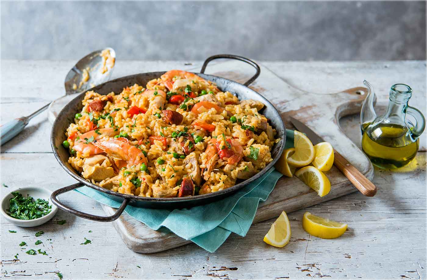 Close-up of a traditional Spanish paella showcasing perfectly cooked rice, juicy seafood, and fresh parsley
