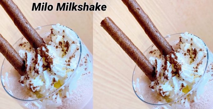 Gelas tinggi berisi Milo milkshake creamy dengan whipped cream di atasnya